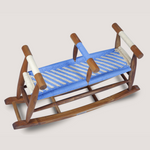 Wooden rocking chair with a blue cushion