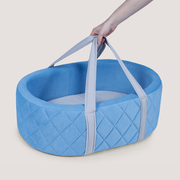 Blue quilted baby bassinet with handles