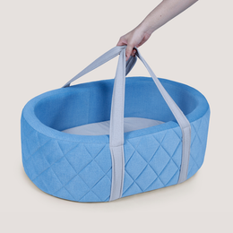 Blue quilted baby bassinet with handles
