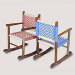 Two wooden rocking chairs with colorful woven seats on a light gray background